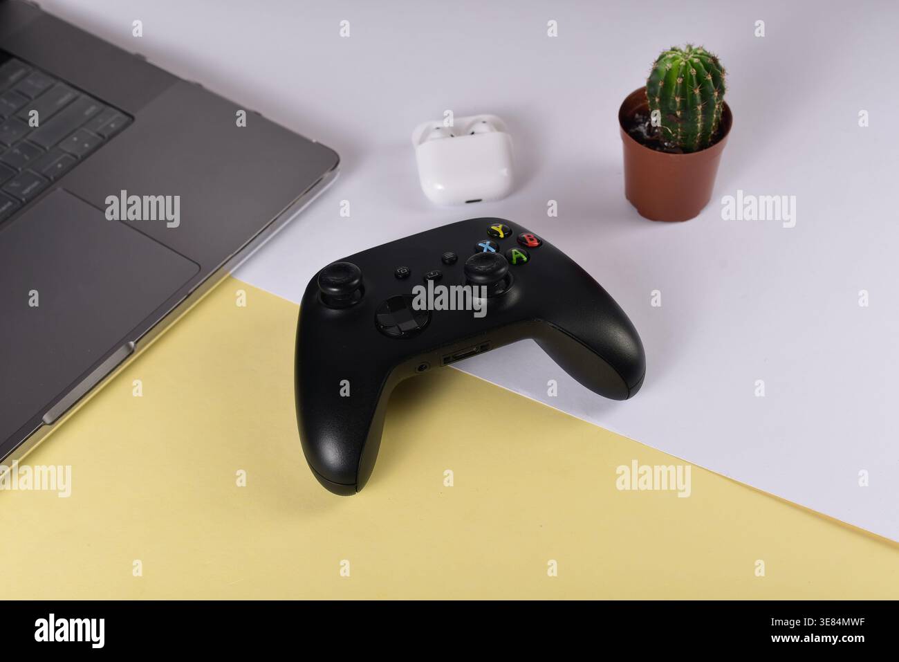 Black videogame controller on desk surface Stock Photo