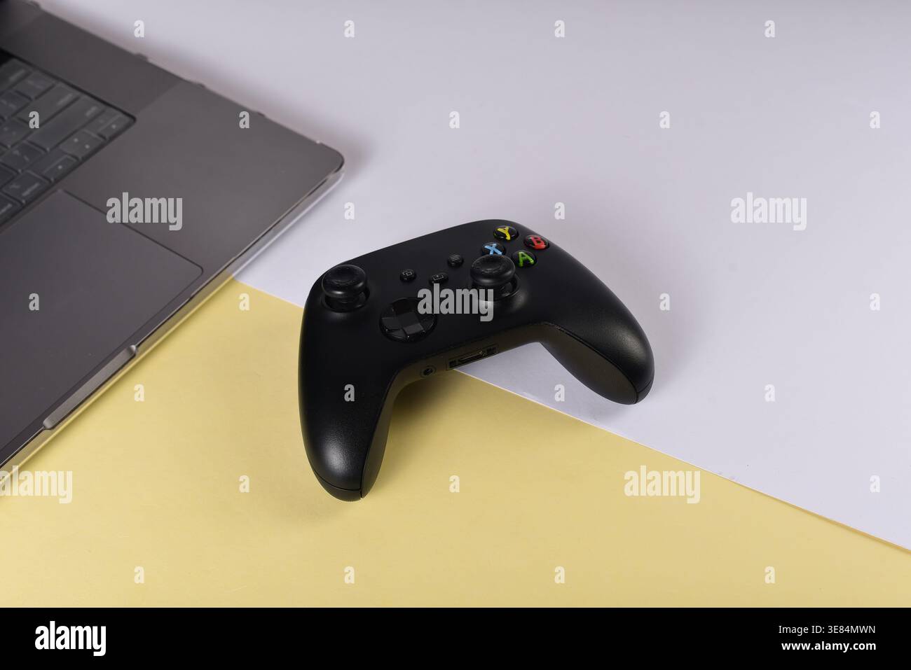 Black videogame controller on desk surface Stock Photo