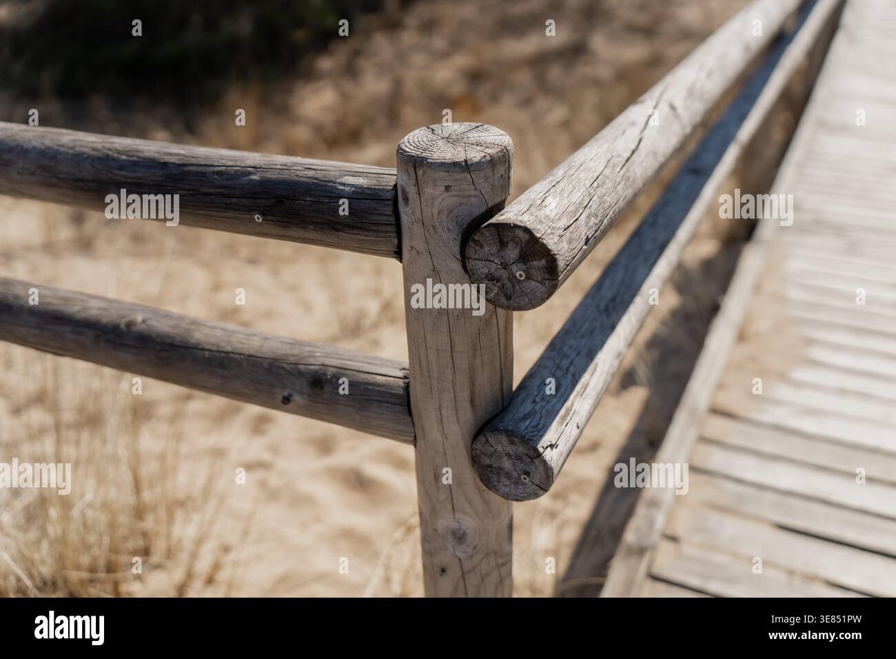 Boardwalk Hand Rails Rustic timber handrail on beach boardwalk with sand below, shoreline ...