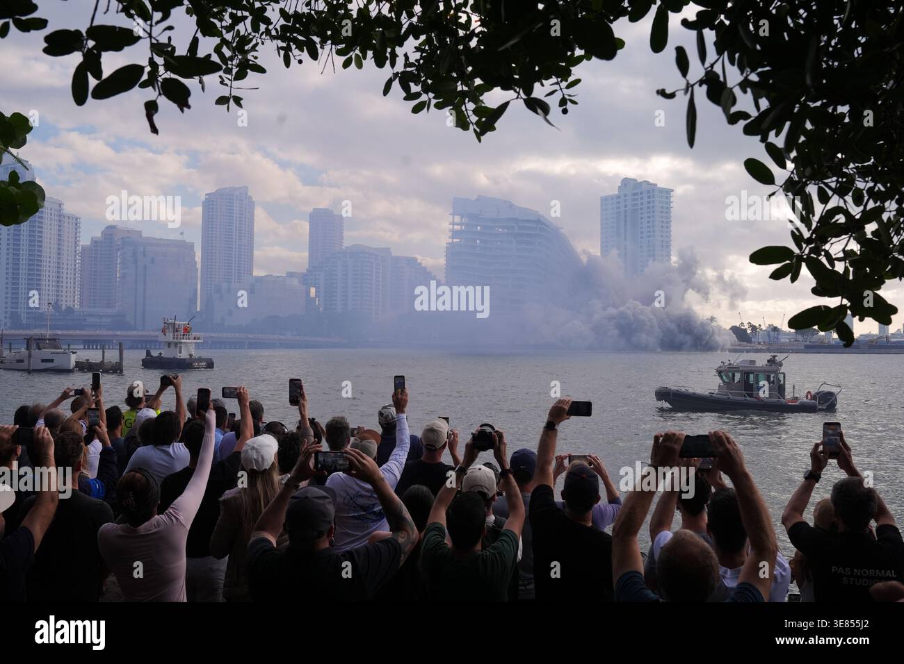 People watch the controlled implosion of the former Mandarin Oriental ...