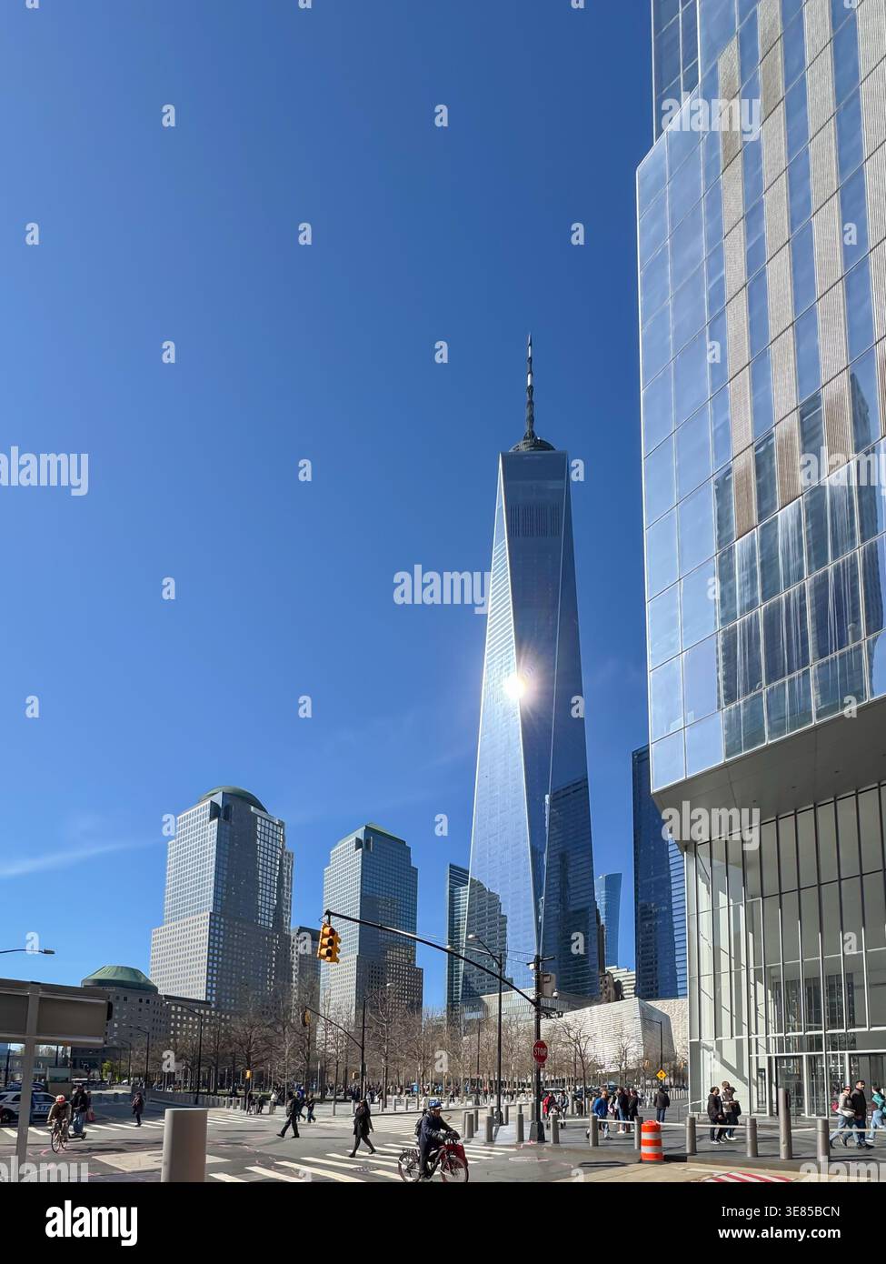 USA New York April 17, 2025. One World Trade Center rises above modern skyscrapers in Lower Manhattan. The glass tower reflects bright sunlight over t Stock Photo