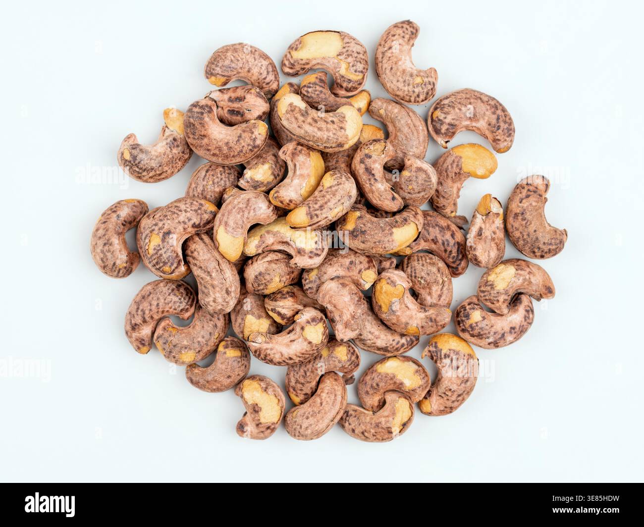 Cashew nuts in shell on light background, top view Stock Photo