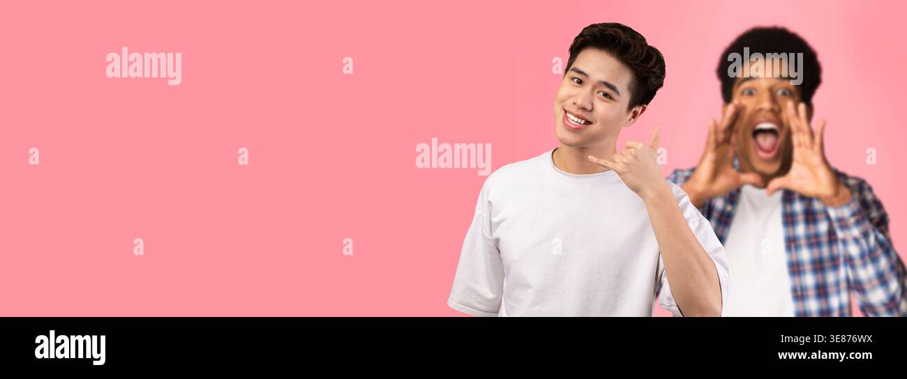 Smiling Asian Man Doing Call Me Gesture in Fun Studio Background Stock Photo