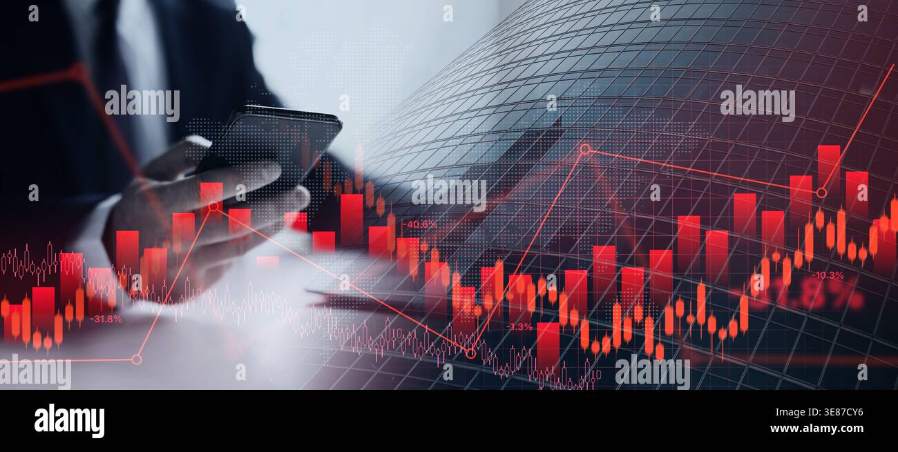 Man Using Smartphone While Analyzing Stock Market Data During Work Hours in Office Setting Stock Photo