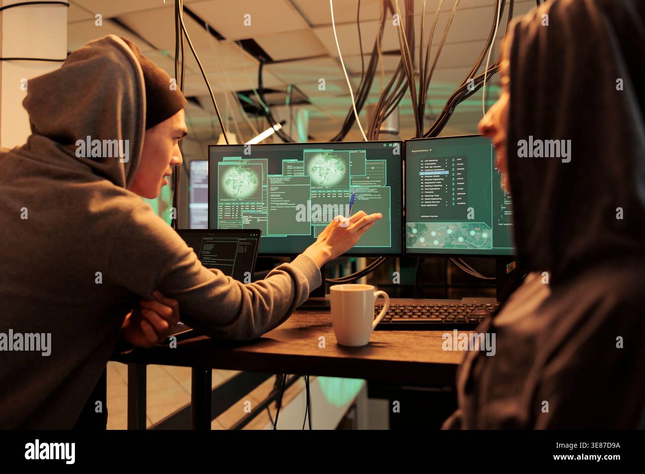 Cybercrime, criminals hacking server, stealing analytics data, developers programming illegal firewall. Hackers cracking computer system password at night time, corporate information leak Stock Photo