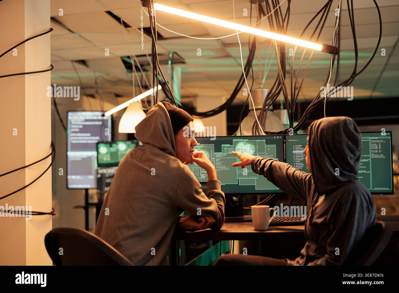 Cybercrime, hackers planning ransomware attack, hacking server, stealing data, discussing illegal malware code. Scammers cracking computer system password at night time, information leak Stock Photo