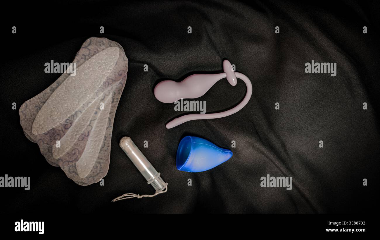 Womens Intimate Care Products and Pelvic Floor Trainer on Black Background Stock Photo