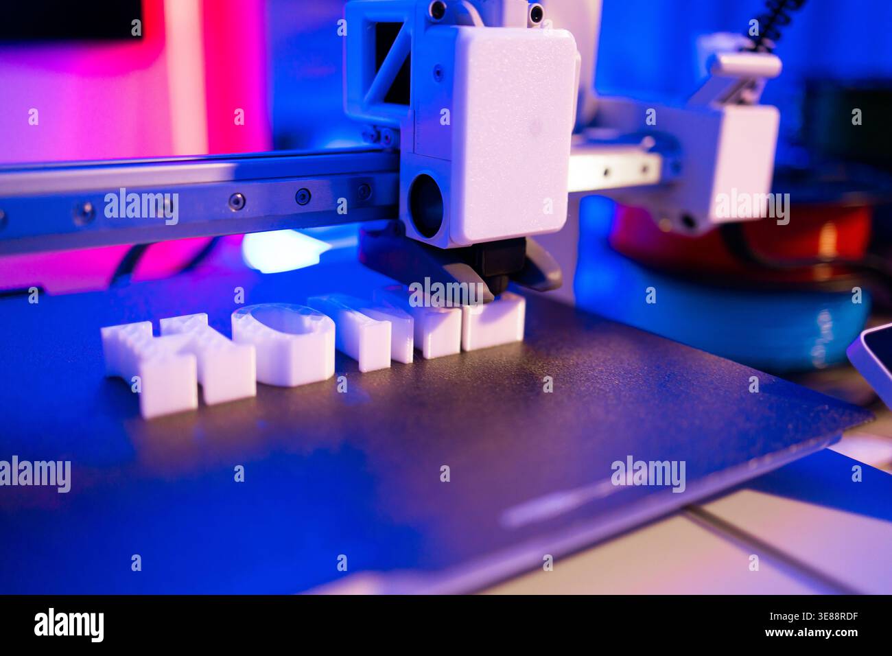 3D Printer Creating White Letters Stock Photo