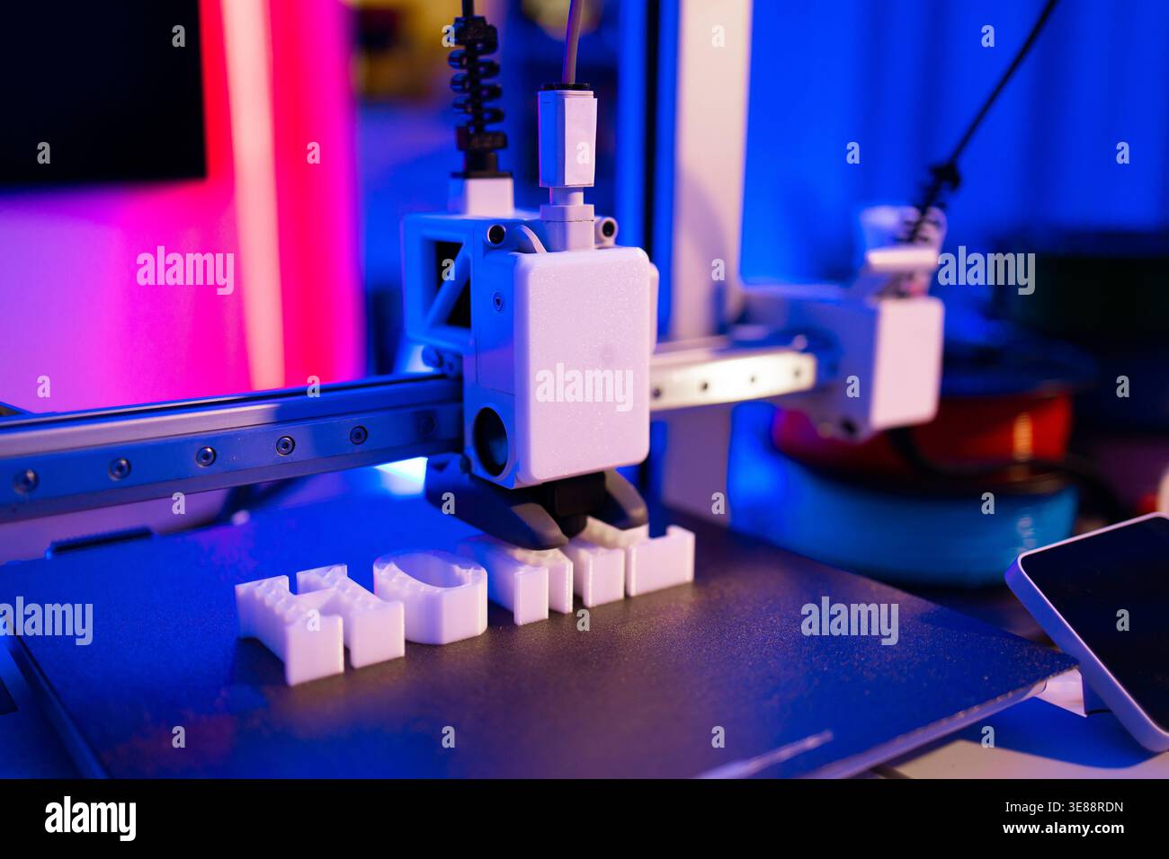 3D Printer Creating White Letters Stock Photo