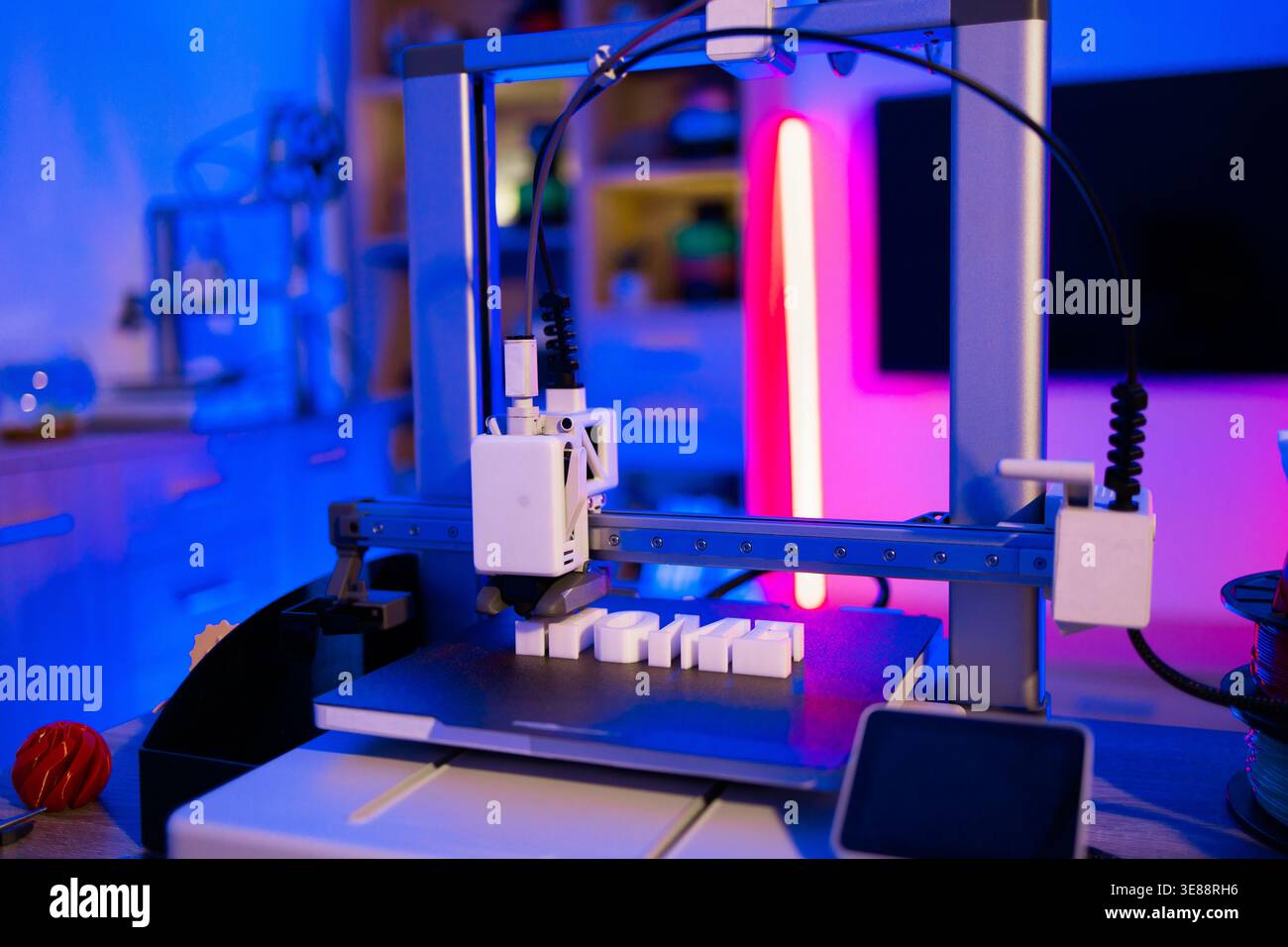 3D Printer Creating White Letters Stock Photo