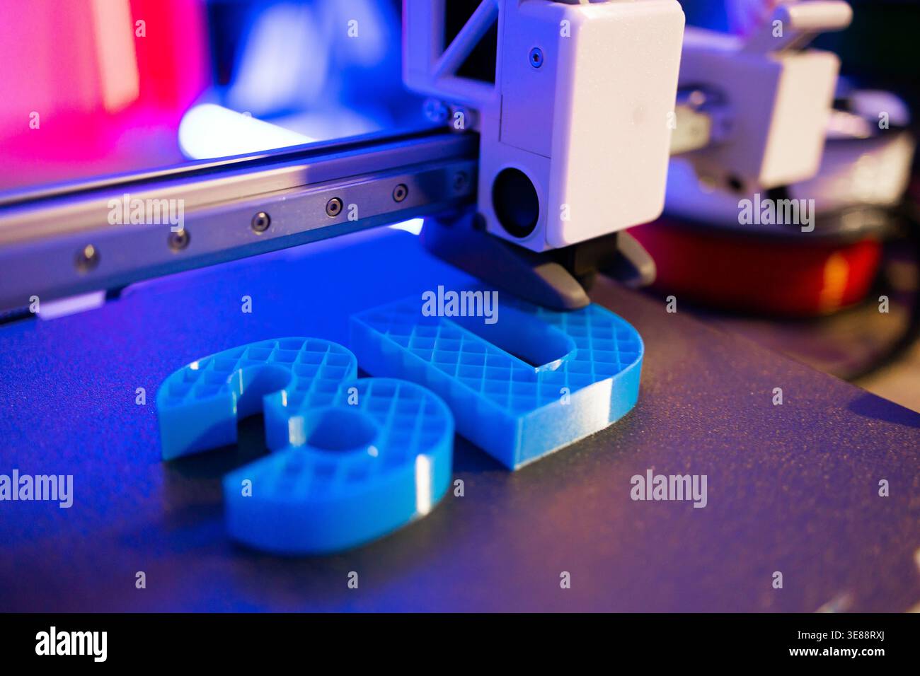 3D Printer Creating Blue Objects Stock Photo