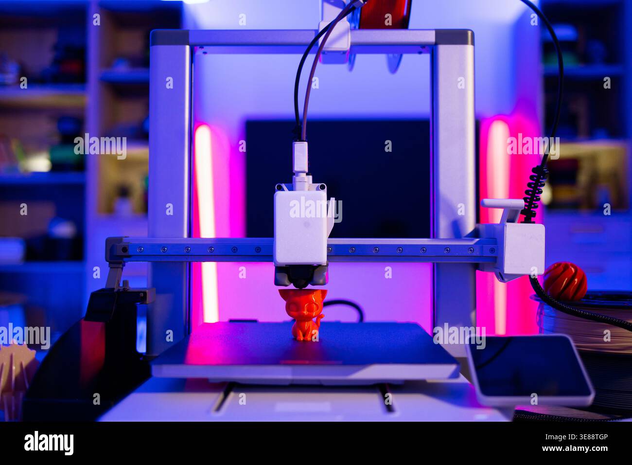 3D Printer Creating Cat Figurine Stock Photo