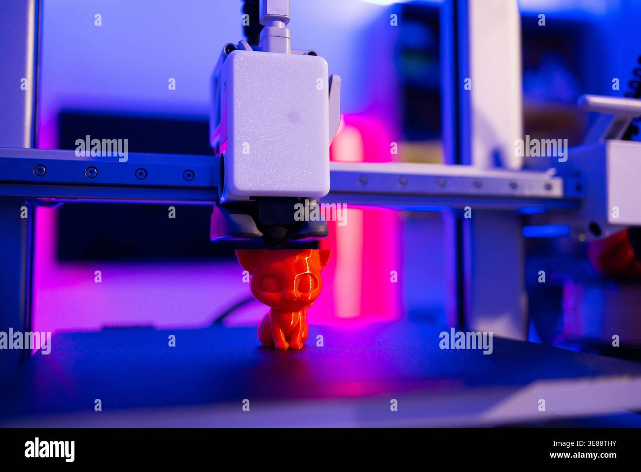 3D Printer Creating Cat Figurine Stock Photo