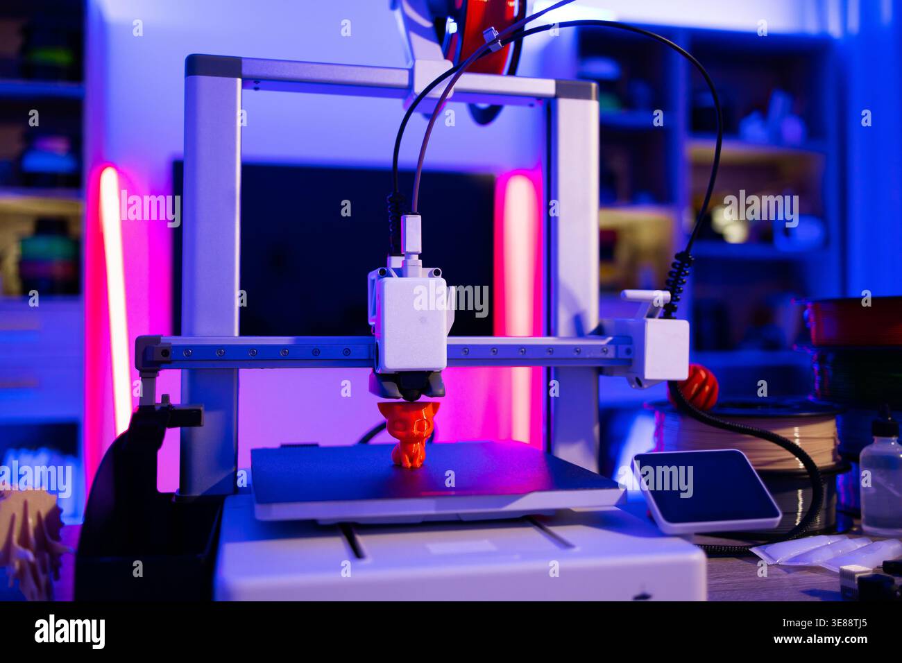 3D Printer Creating Orange Object Stock Photo