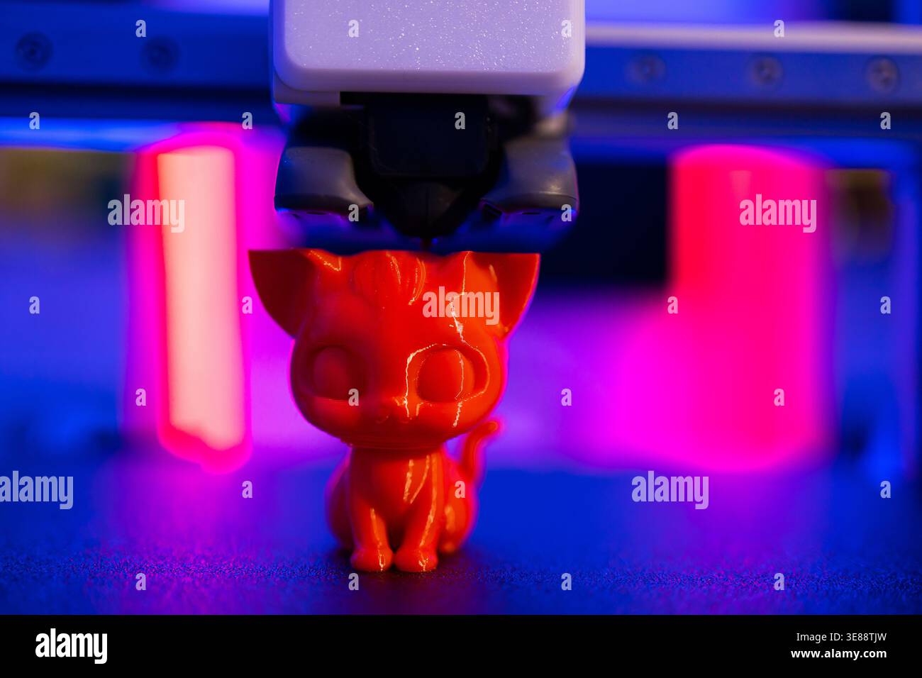 3D Printer Creating Cat Figurine Stock Photo
