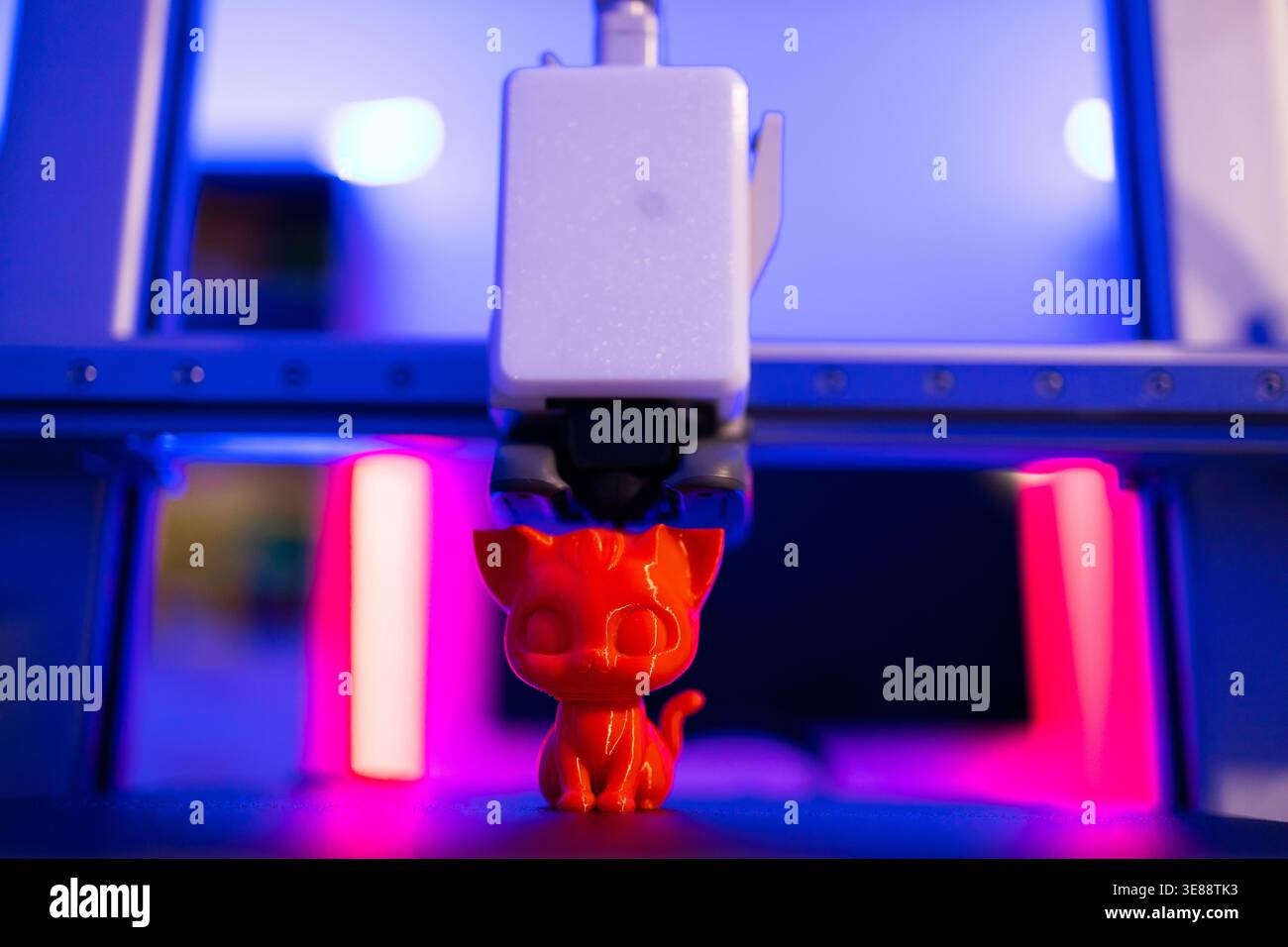 3D Printer Creating Cat Figurine Stock Photo
