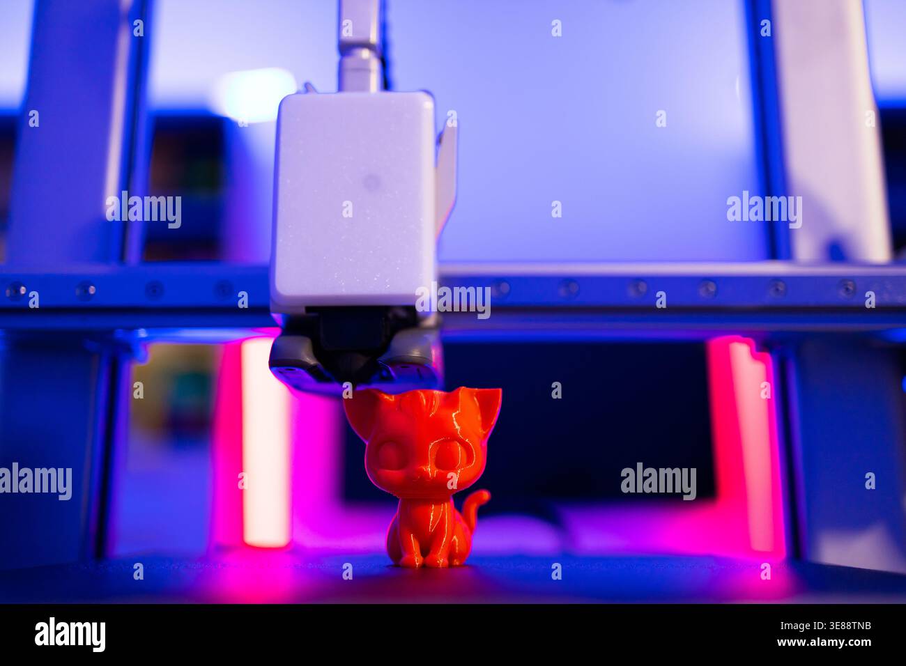 3D Printer Creating Cat Figurine Stock Photo