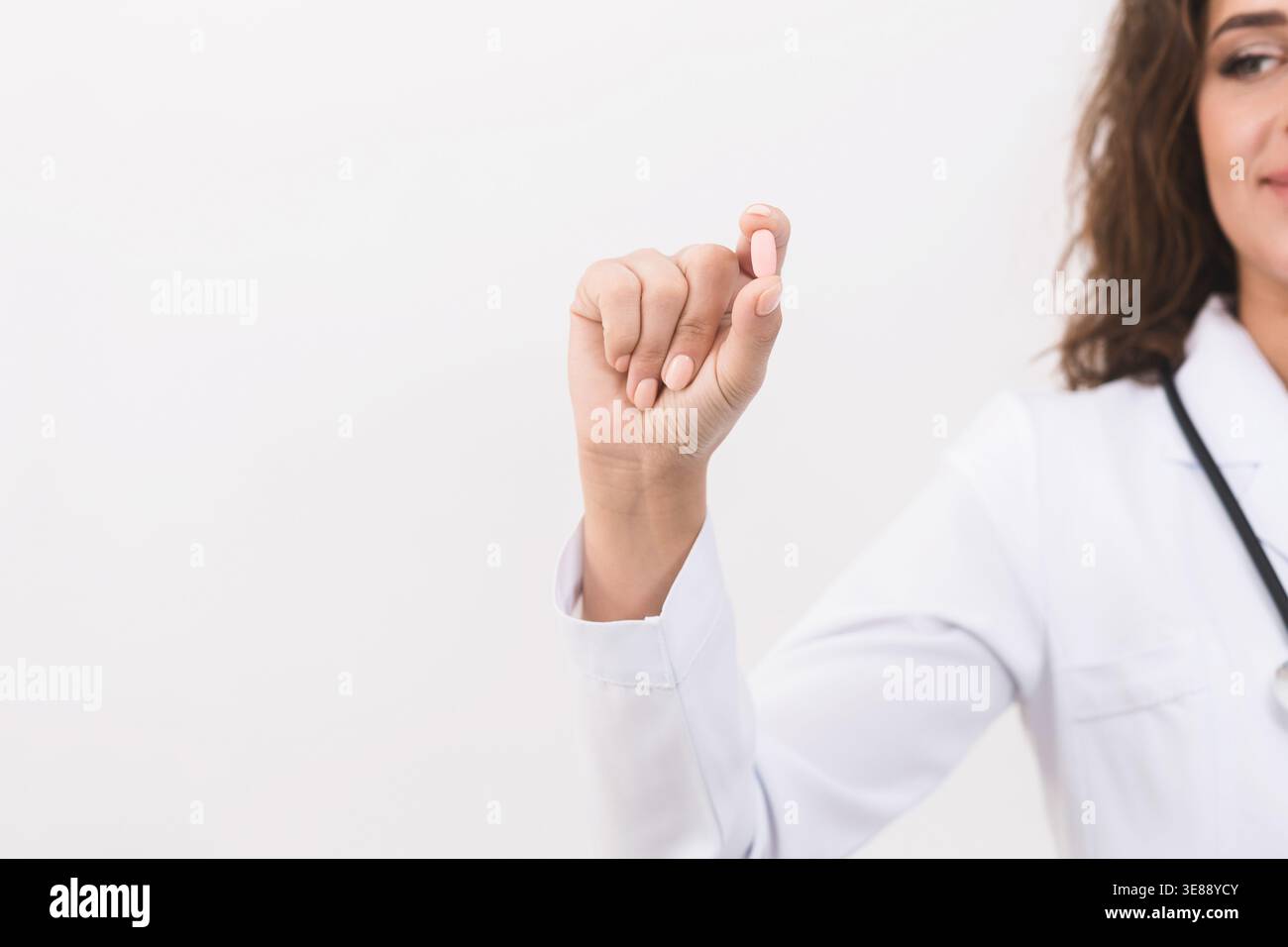 Doctor hand showing pill on white background Stock Photo