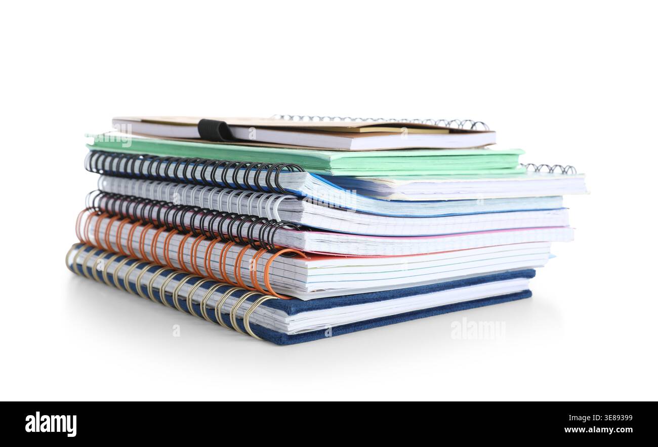 Stack of many different notebooks isolated on white background Stock Photo