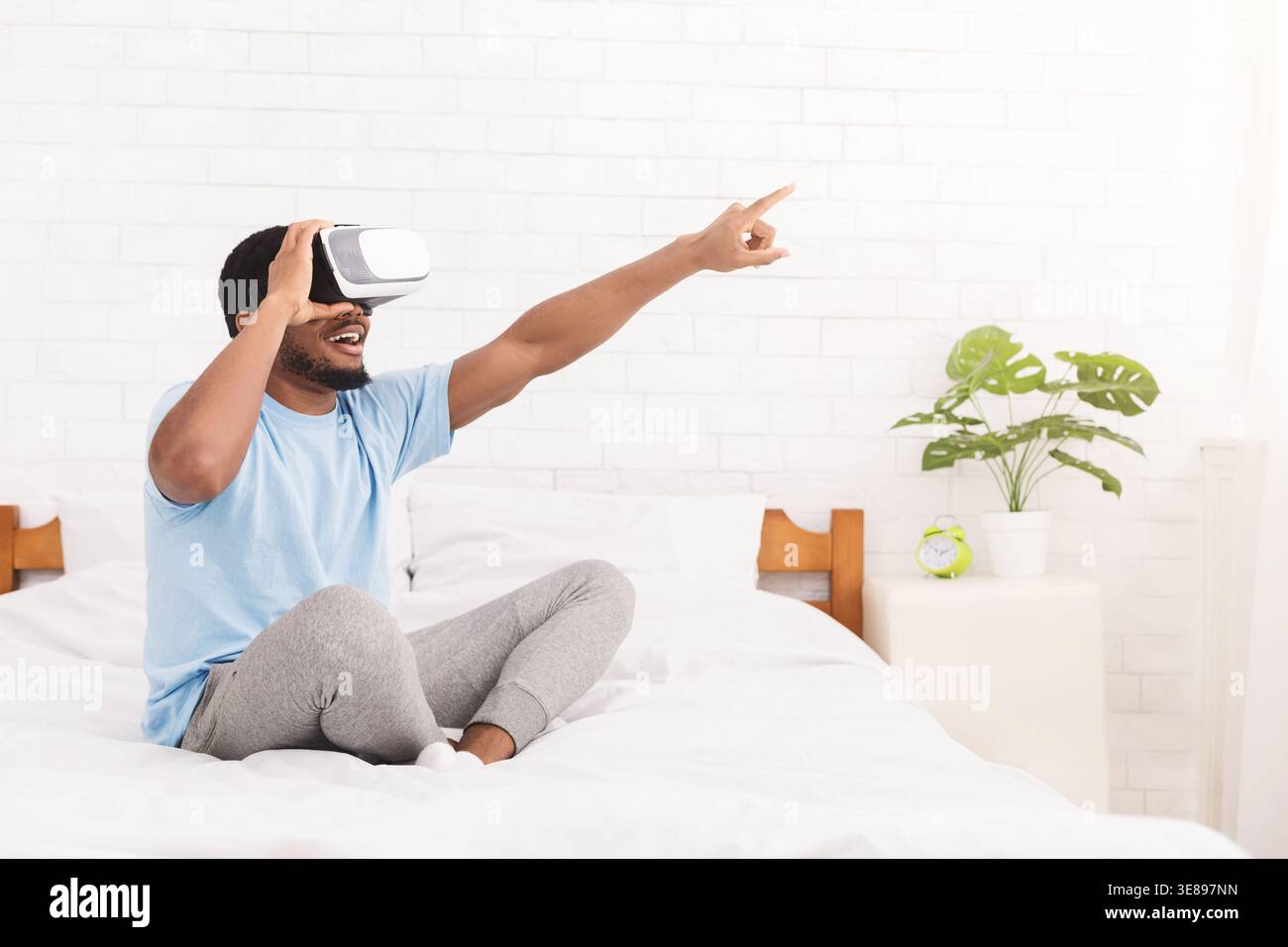 Excited young black man using virtual reality headset Stock Photo