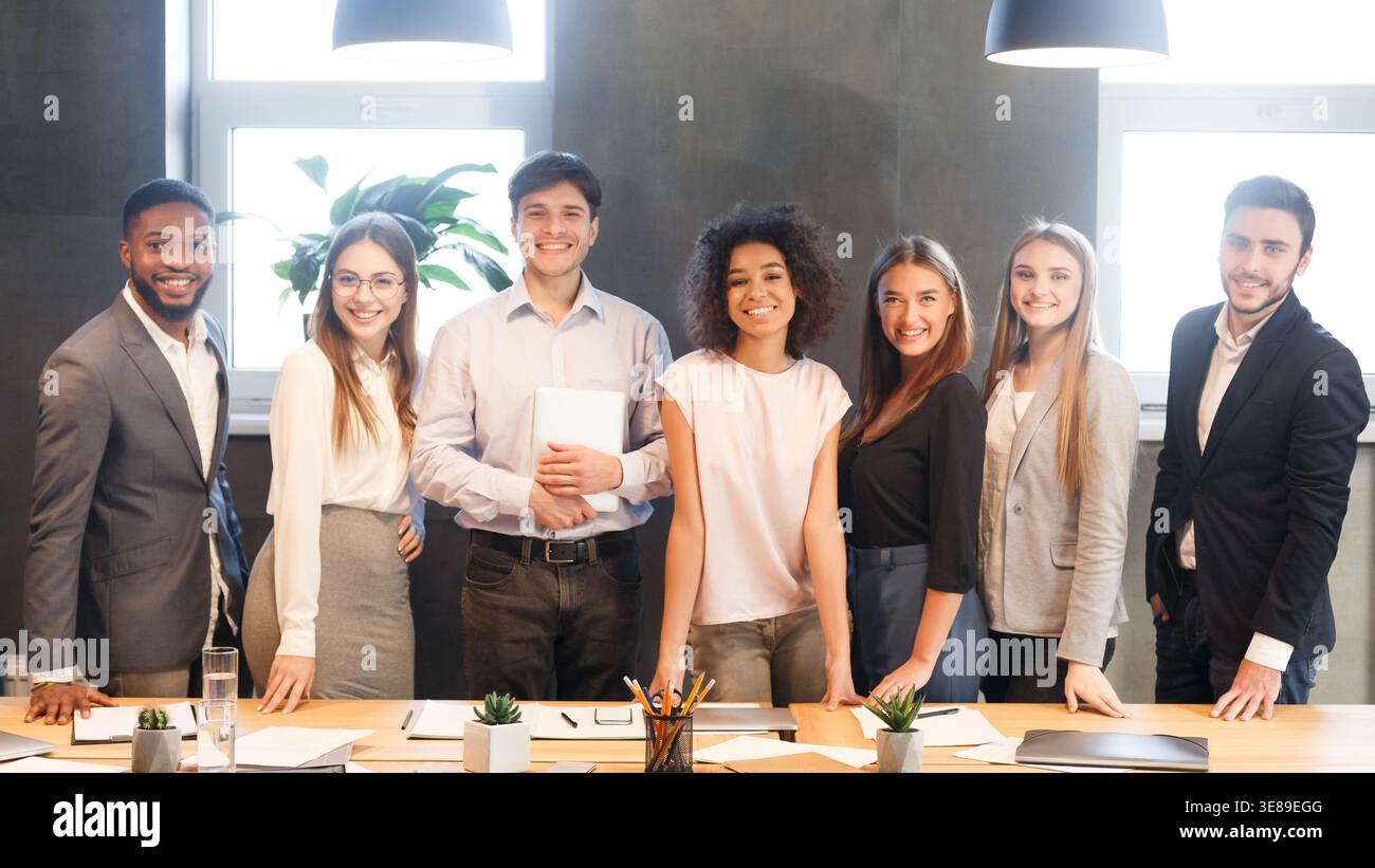 Young business team smiling to camera, having break Stock Photo