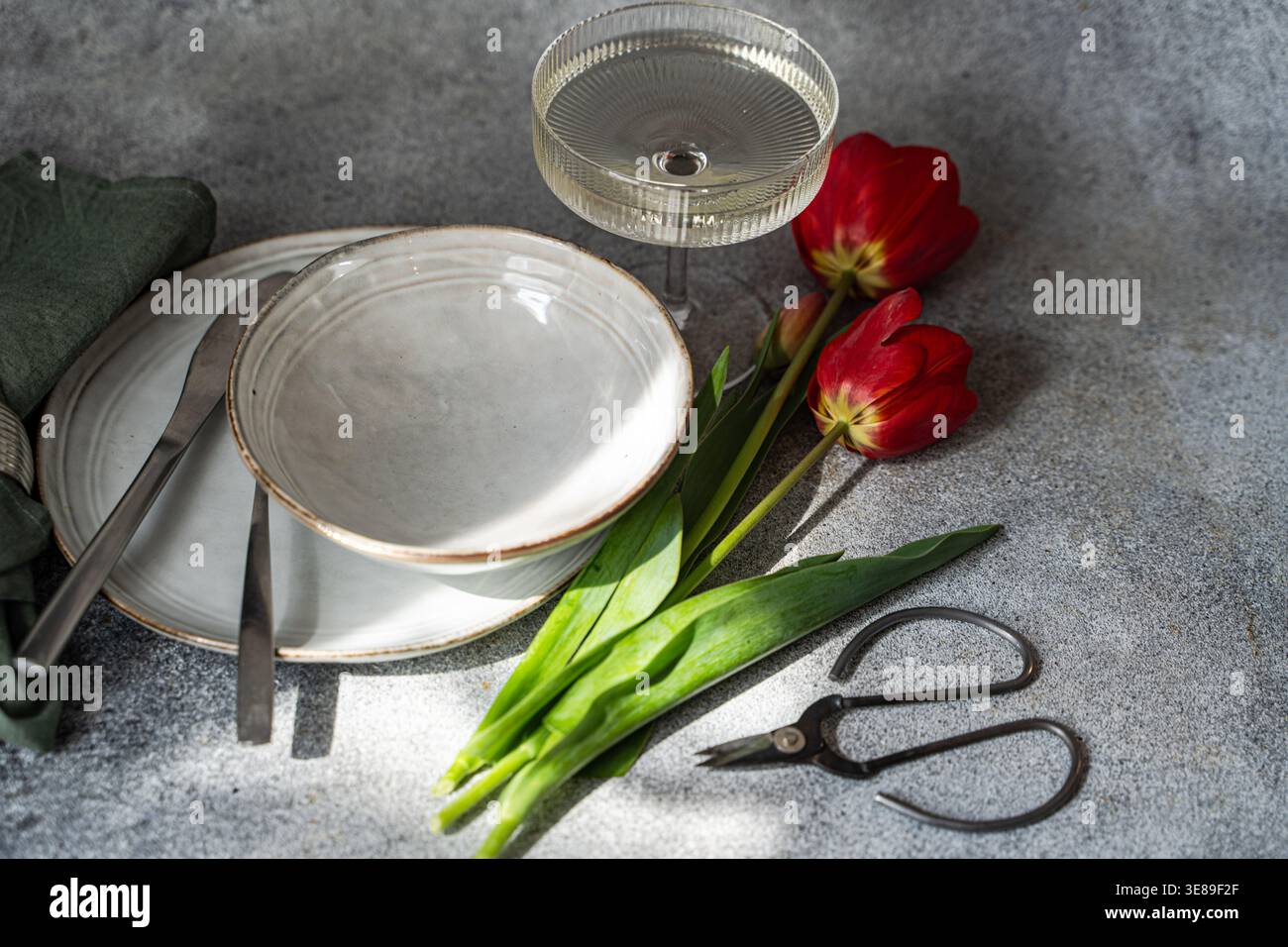 Table setting with beautiful red tulips Stock Photo