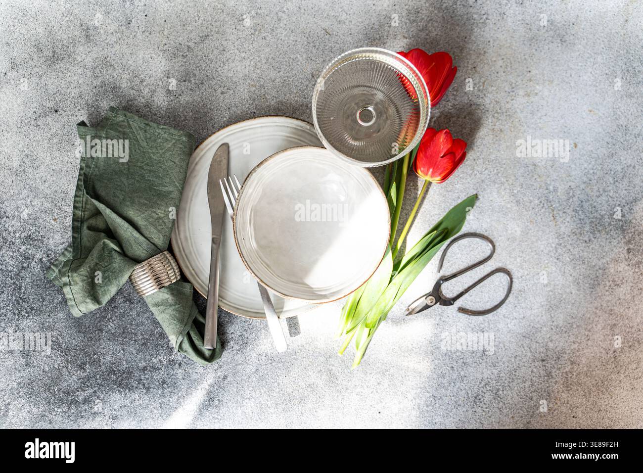 Table setting with beautiful red tulips Stock Photo