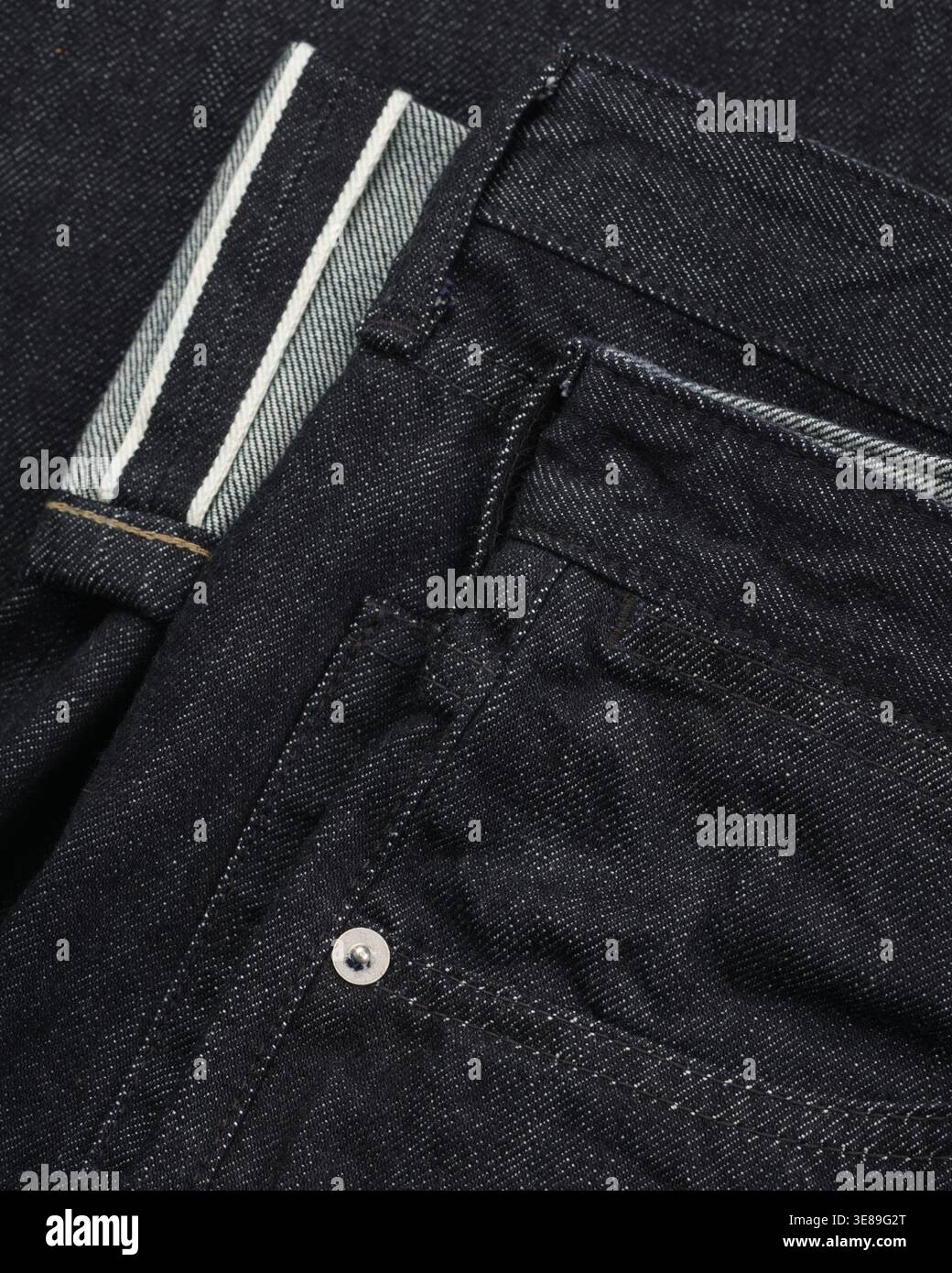 Dark denim jeans texture close-up fabric background Stock Photo