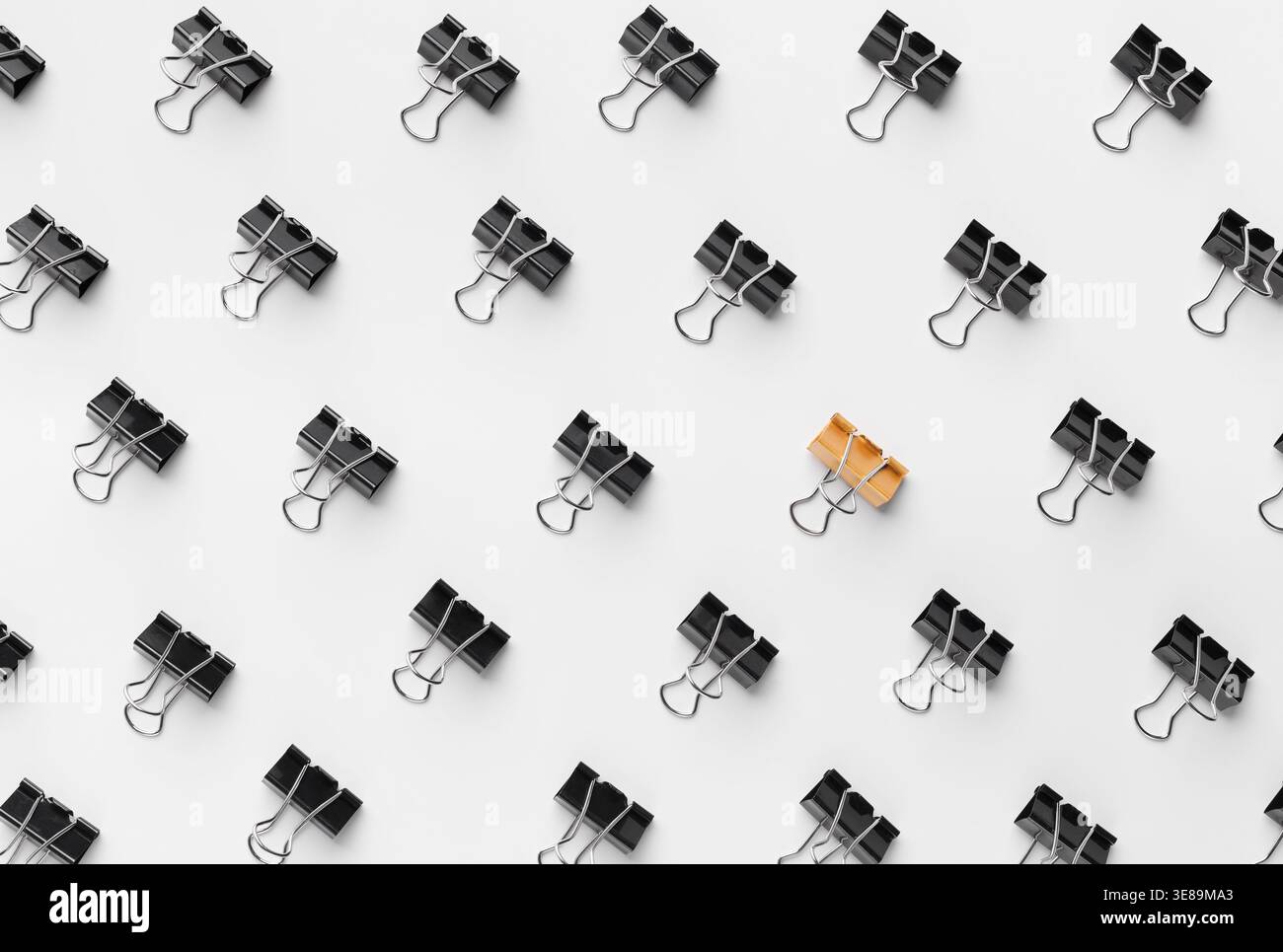 Binder Clips Are Arranged in a Pattern on a White Surface Stock Photo