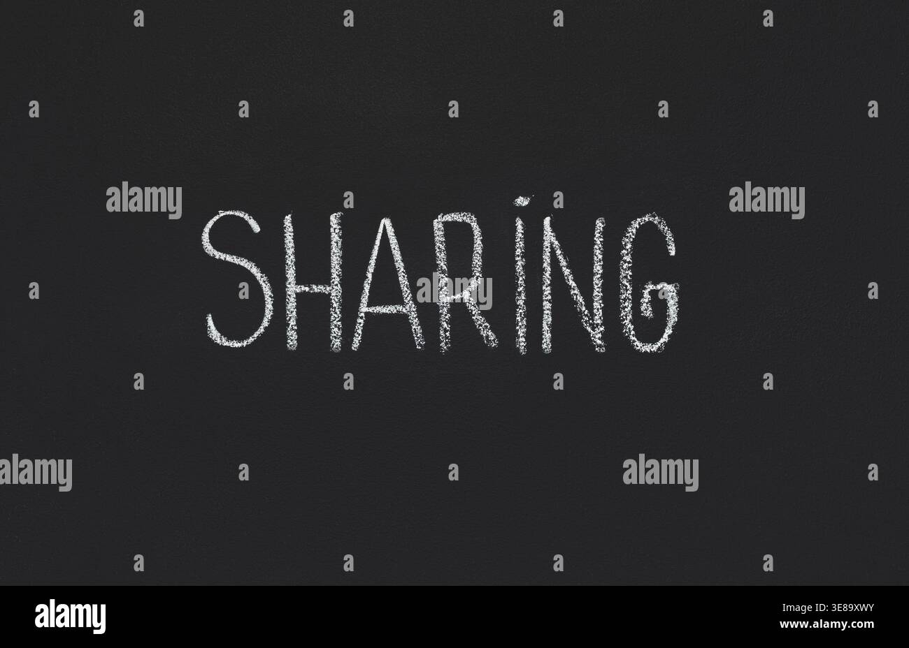 Word Sharing written on black chalkboard, copy space Stock Photo