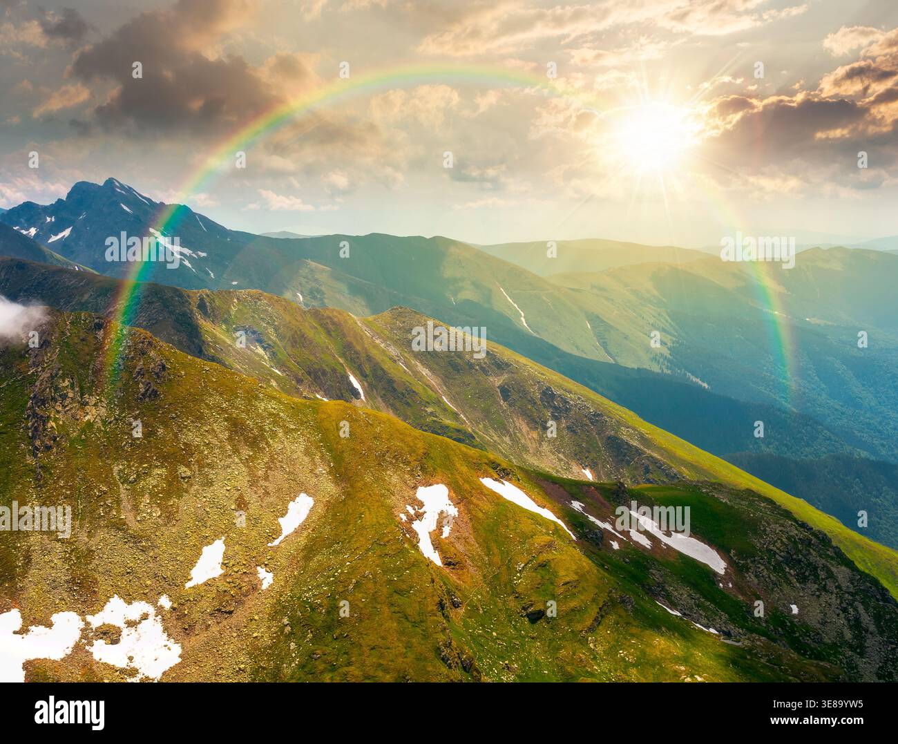 sunset over mountain scenery in summer. gorgeous mountainous landscape. background with rocky cliffs and grassy hillsides under a cloudy sky. ridge of Stock Photo