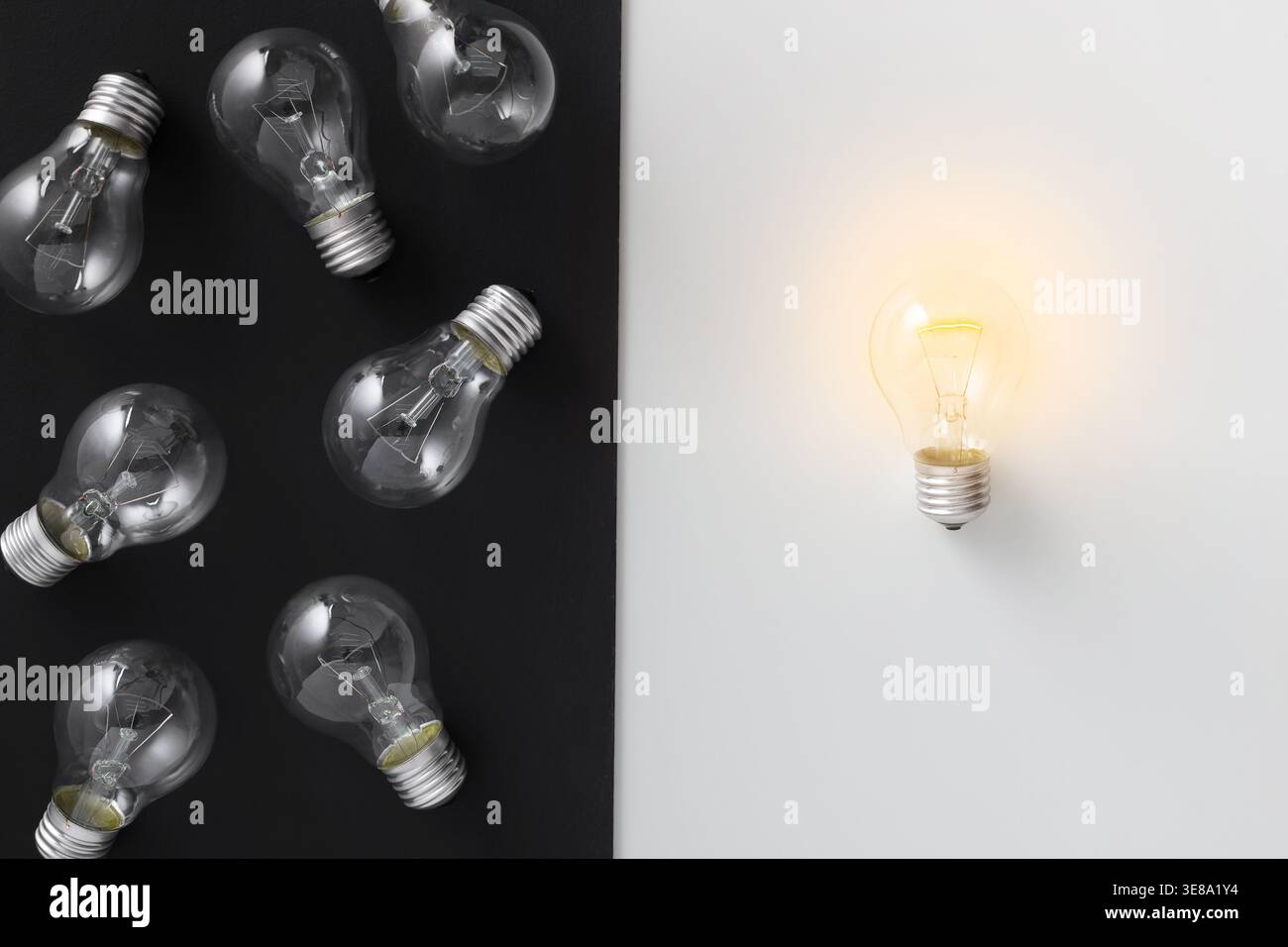 Illuminated lamp separated from other on contrast background Stock Photo