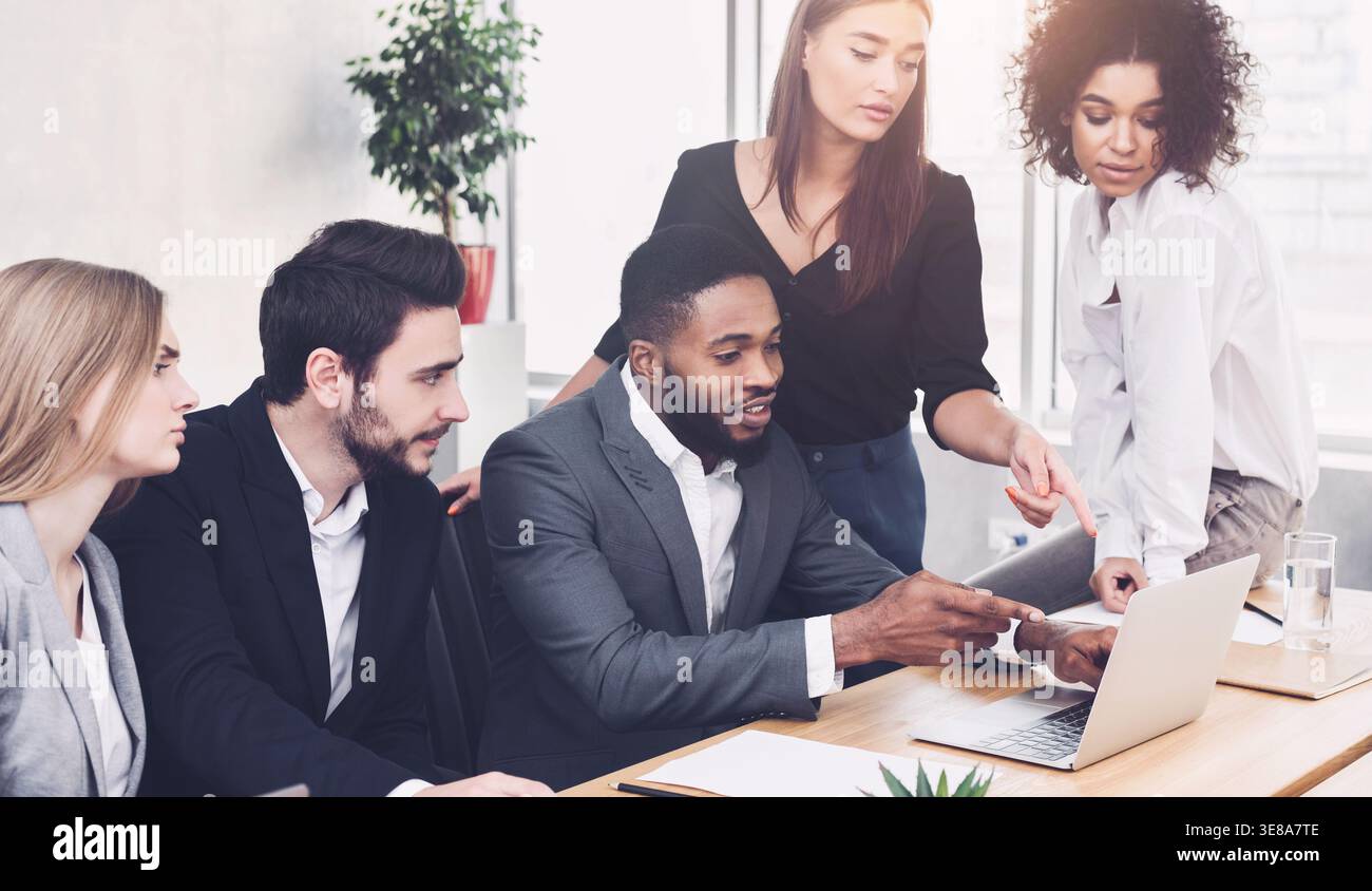 Business discussion. Colleagues analyzing data on laptop Stock Photo