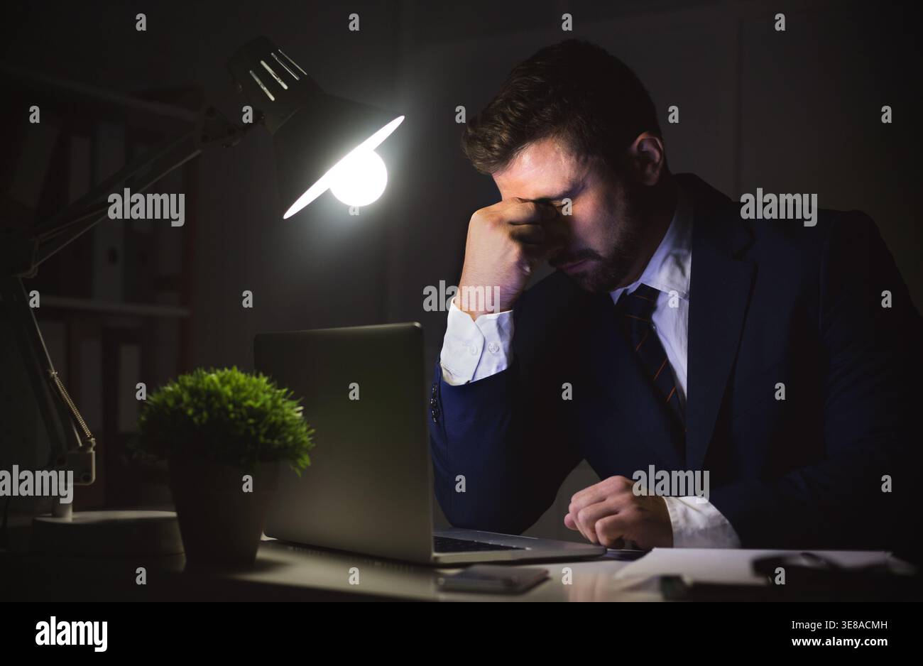 Stressed businessman working on laptop, having problems Stock Photo