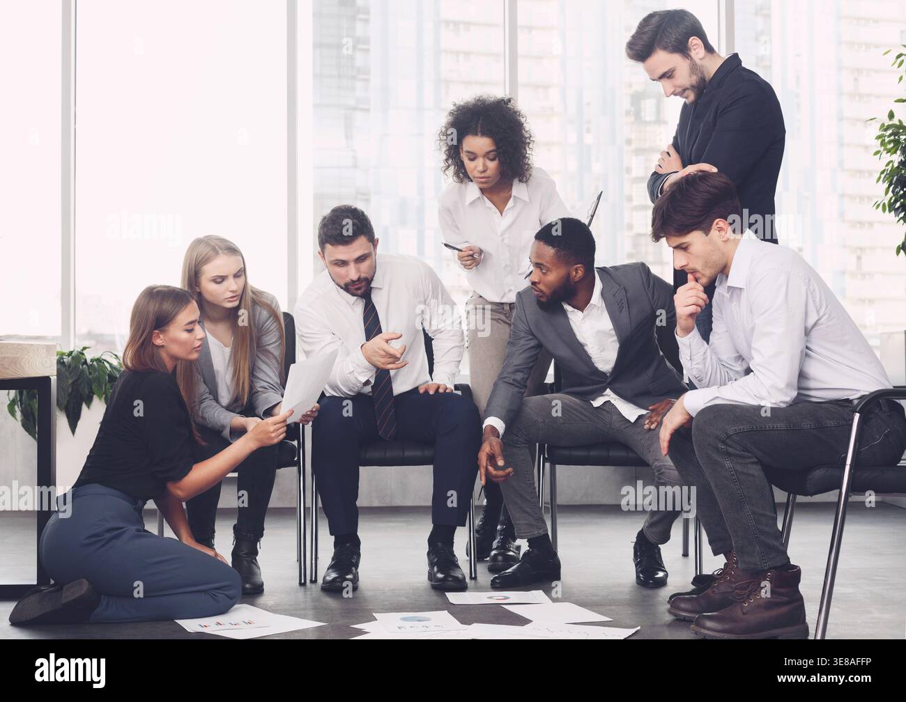 Planning strategy together. Business team looking at papers Stock Photo