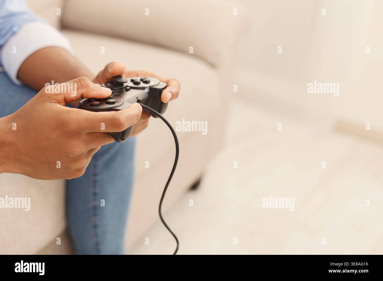 Black man playing video games at home Stock Photo