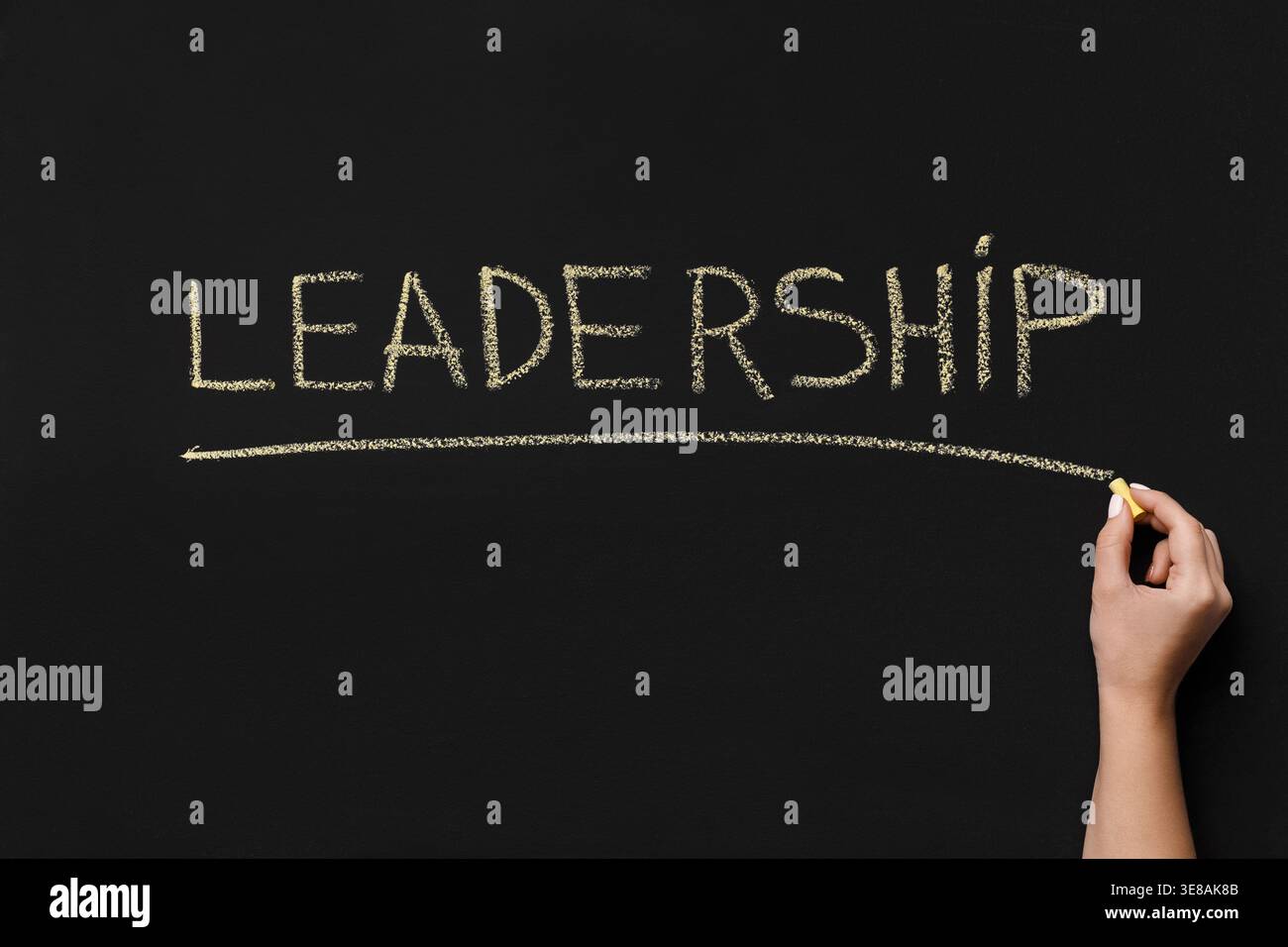 Chalk Writing on a Black Board Showing the Word Leadership With an Underline by a Hand Stock Photo