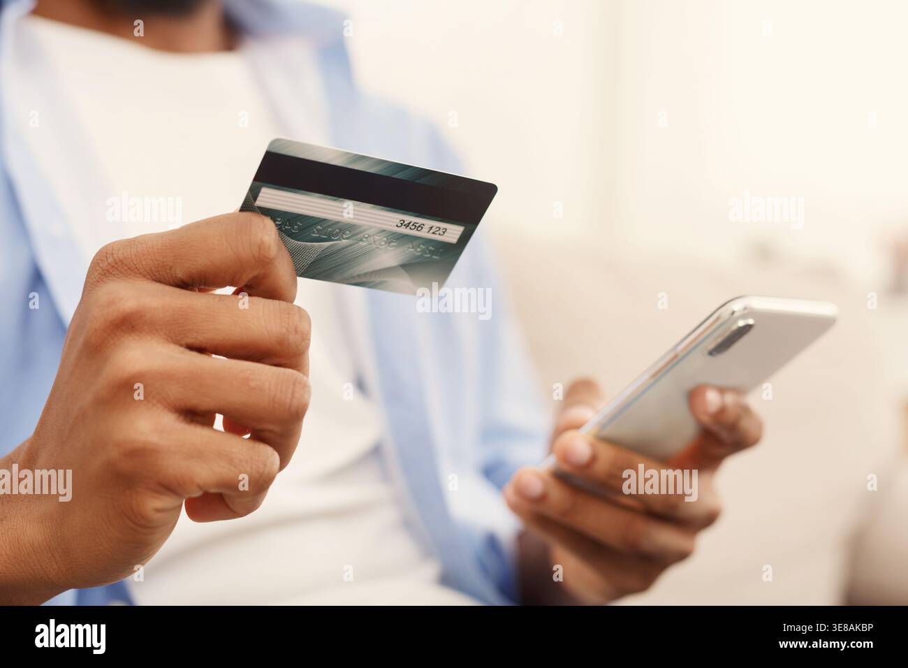African-american man making transaction using mobile application Stock Photo