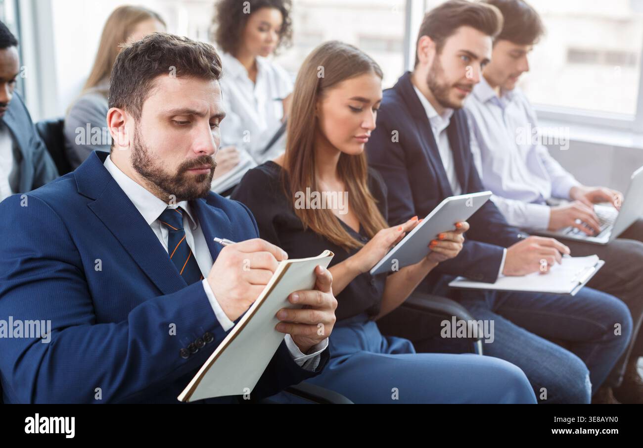 Business training, people making notes at seminar Stock Photo