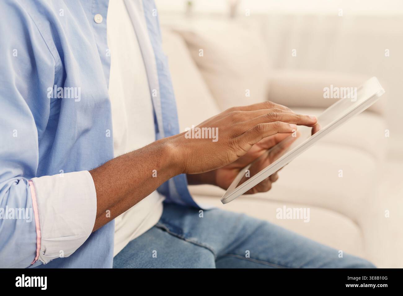 Close up hands of man using digital tablet Stock Photo