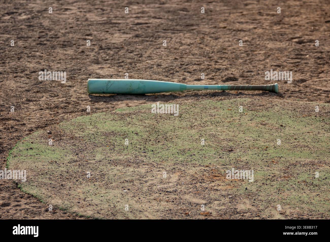 Baseball bat on the field Stock Photo