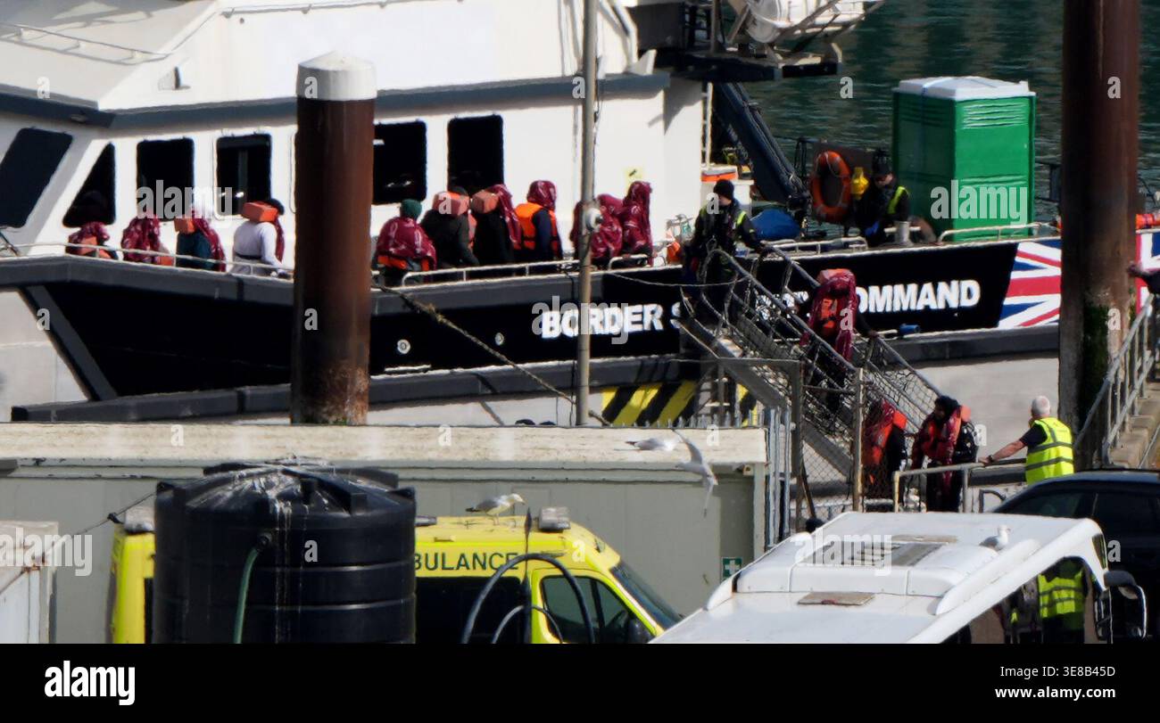 A group of people thought to be migrants are brought in to the Border ...