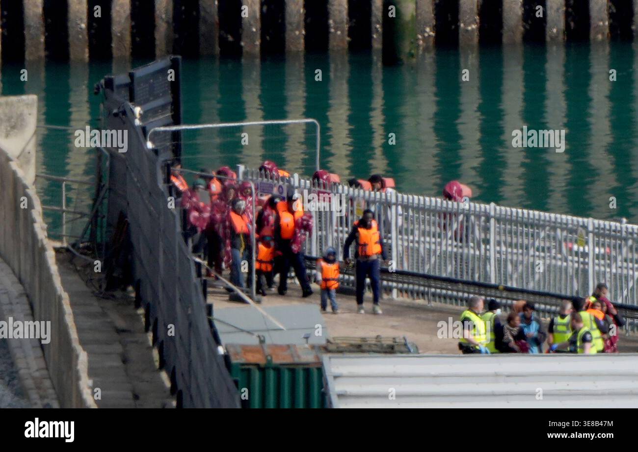 A group of people thought to be migrants are brought in to the Border ...