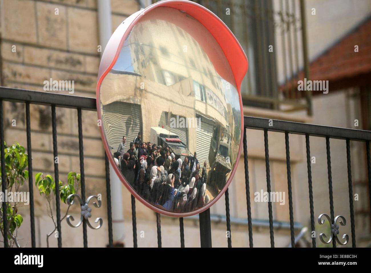 Jenin Checkpoint Palestinians appear in the center of a mirror at an Israeli army ...