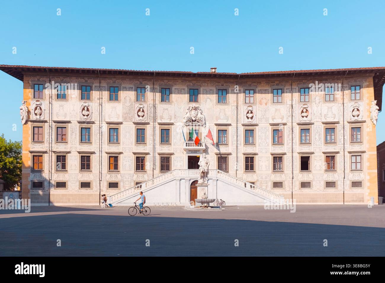 Pisa, Italy: Wide view of the Palazzo della Carovana facade and grand staircase in Piazza dei Cavalieri, home to the Scuola Normale Superiore. Stock Photo