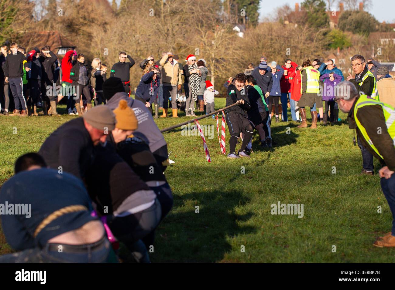 Teams pulling a rope during a community tug of war competition at ...