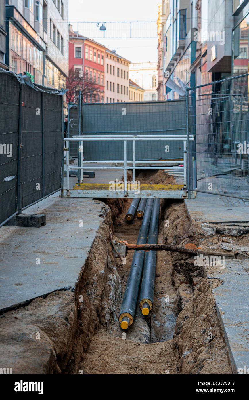 Urban/street Runder An urban street under construction showing an open trench with exposed ...