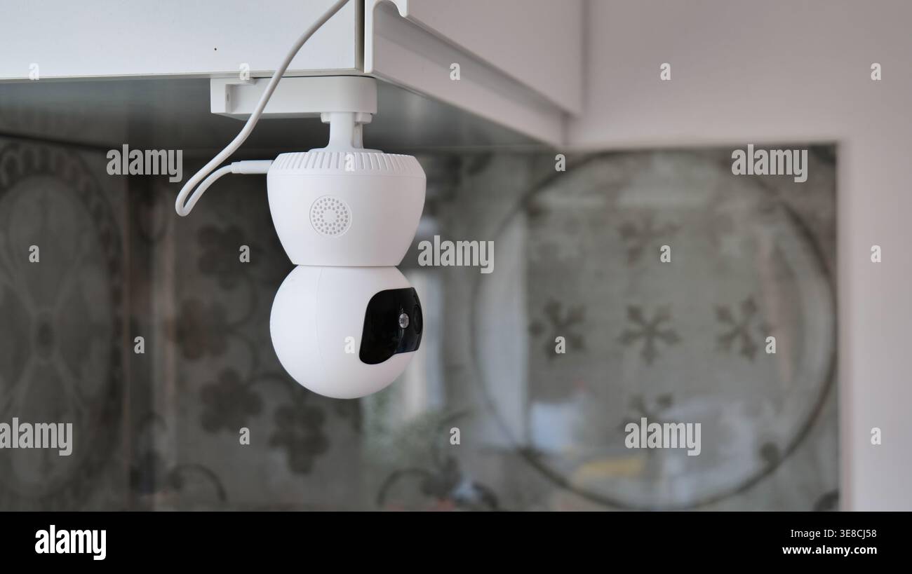 White smart security camera mounted indoors Stock Photo