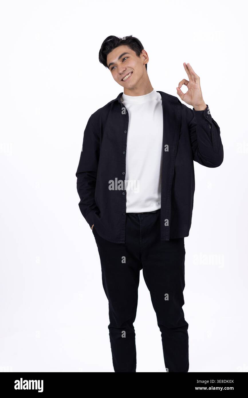 Stylish man showing peace gesture on white background Stock Photo