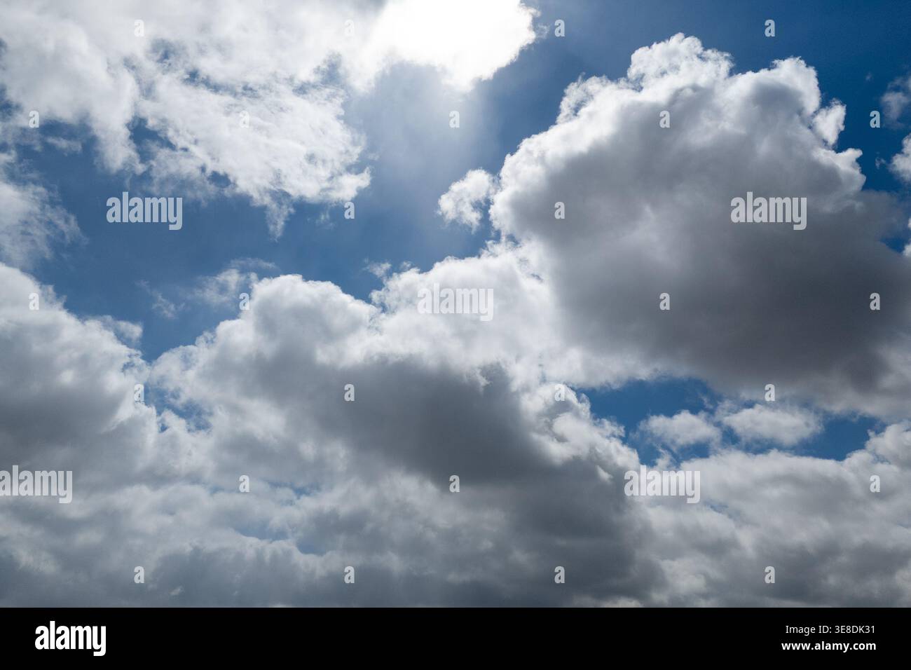 Dramatic white clouds on a deep blue sky background Stock Photo